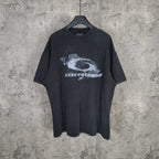 Graphic T-shirt with dark wash and white eye print at center chest