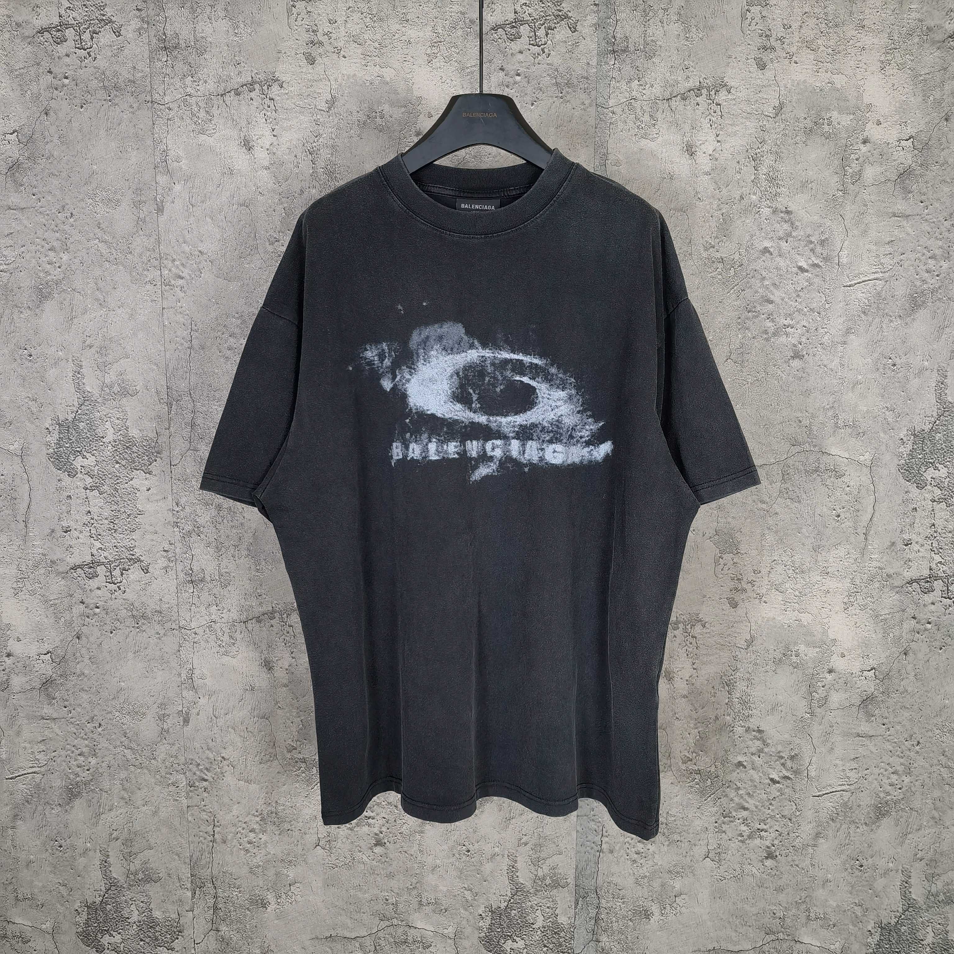 Graphic T-shirt with dark wash and white eye print at center chest