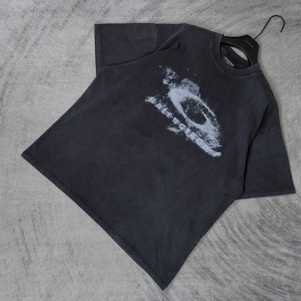 Dark wash crewneck T-shirt laid flat with white eye graphic