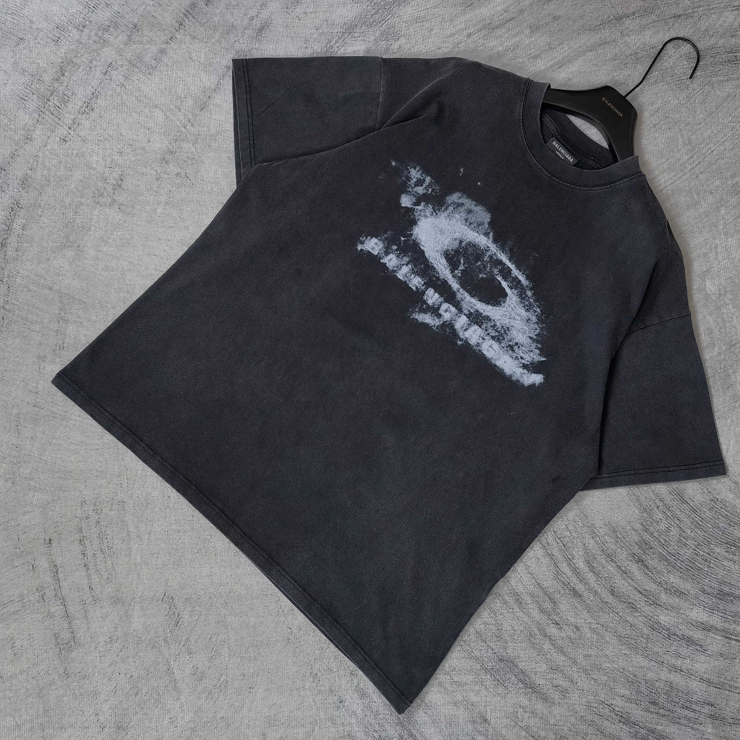 Dark wash crewneck T-shirt laid flat with white eye graphic