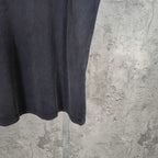 Dark wash T-shirt hem view with straight bottom edge and subtle wear marks