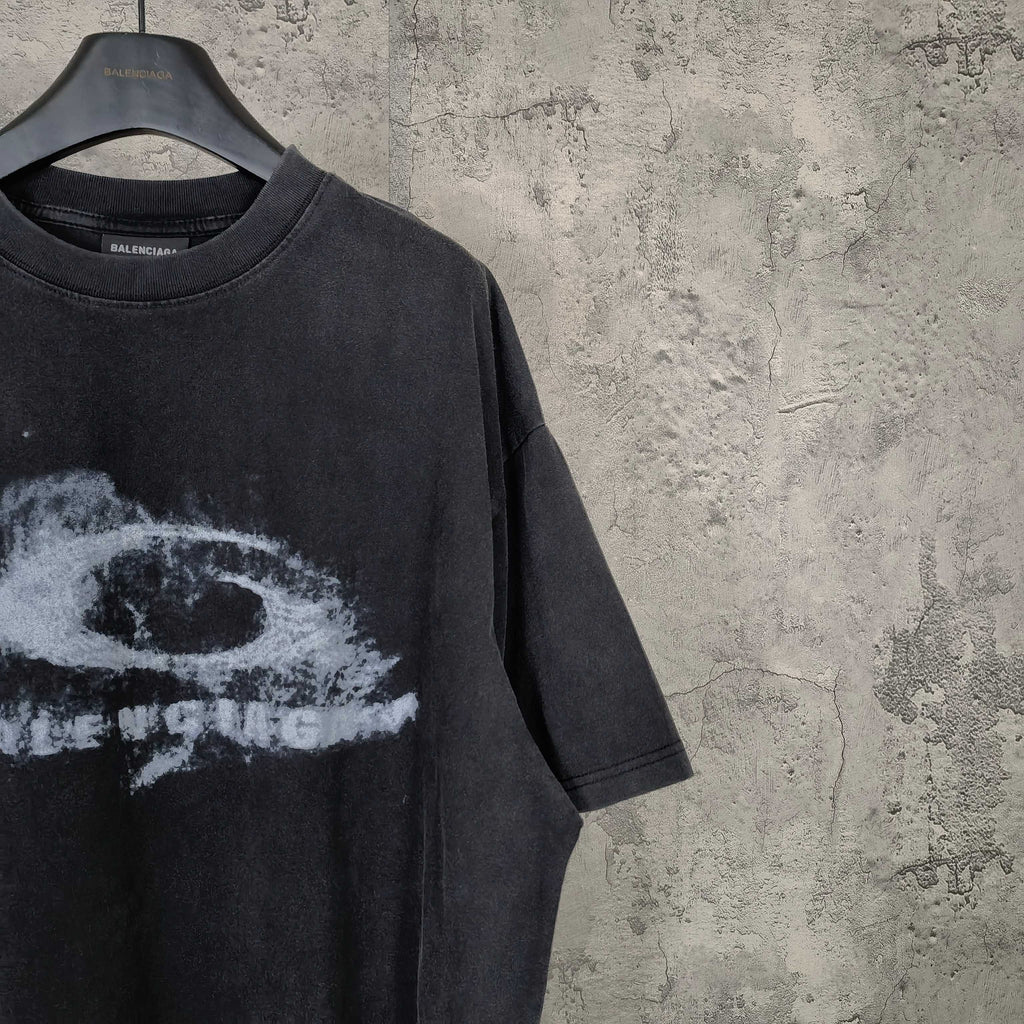 Dark wash T-shirt detail with partial white eye graphic and short sleeve