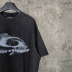 Dark wash T-shirt detail with partial white eye graphic and short sleeve