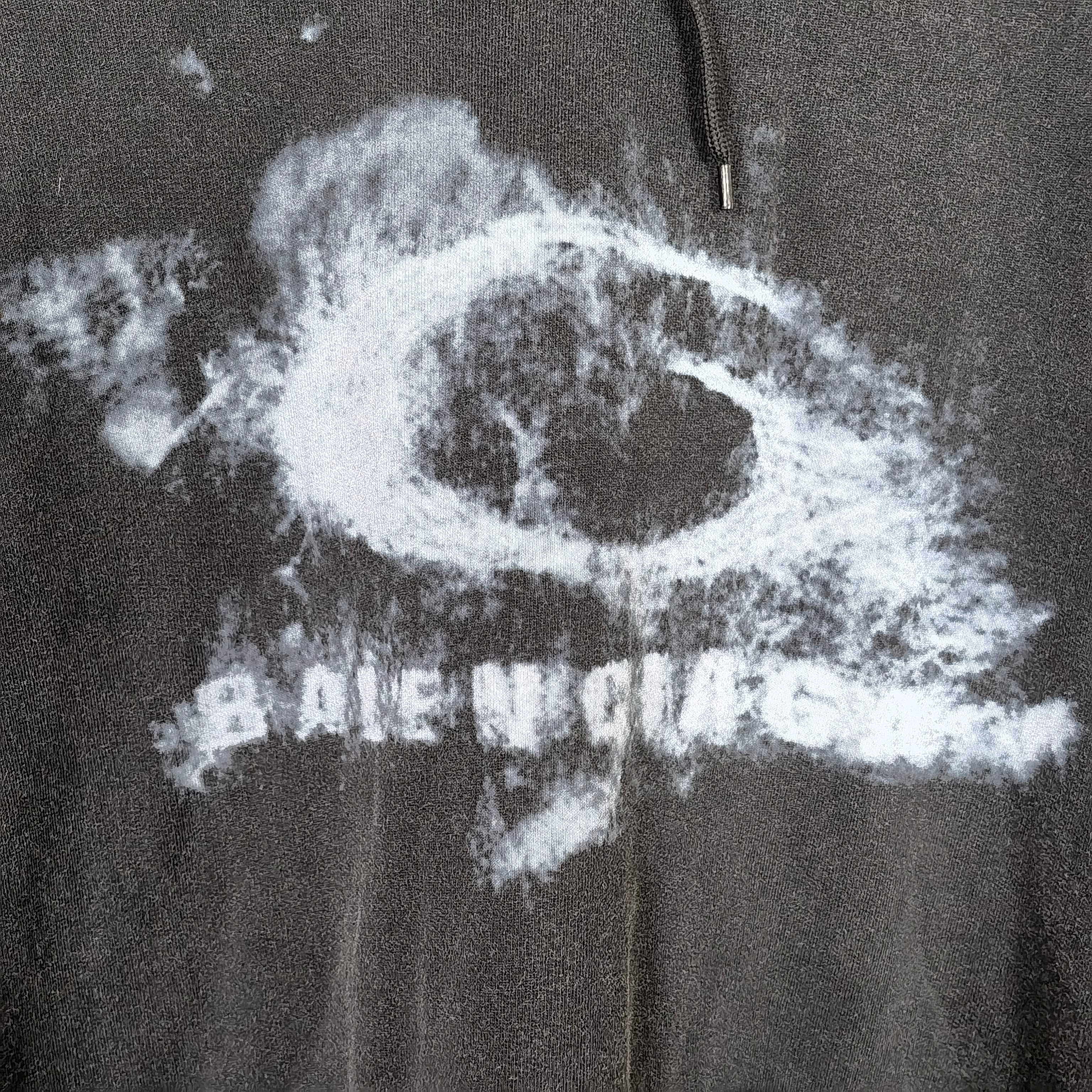 Balenciaga hoodie logo detail in distressed white print on dark fabric