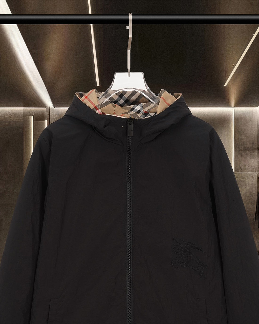 Black hooded long jacket front view with zipper and plaid-lined hood