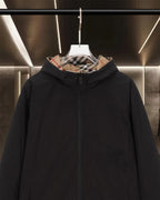 Black hooded long jacket front view with zipper and plaid-lined hood