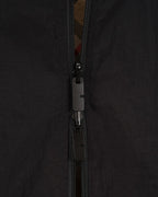 Black jacket zipper close-up with metal pull and fabric tracks
