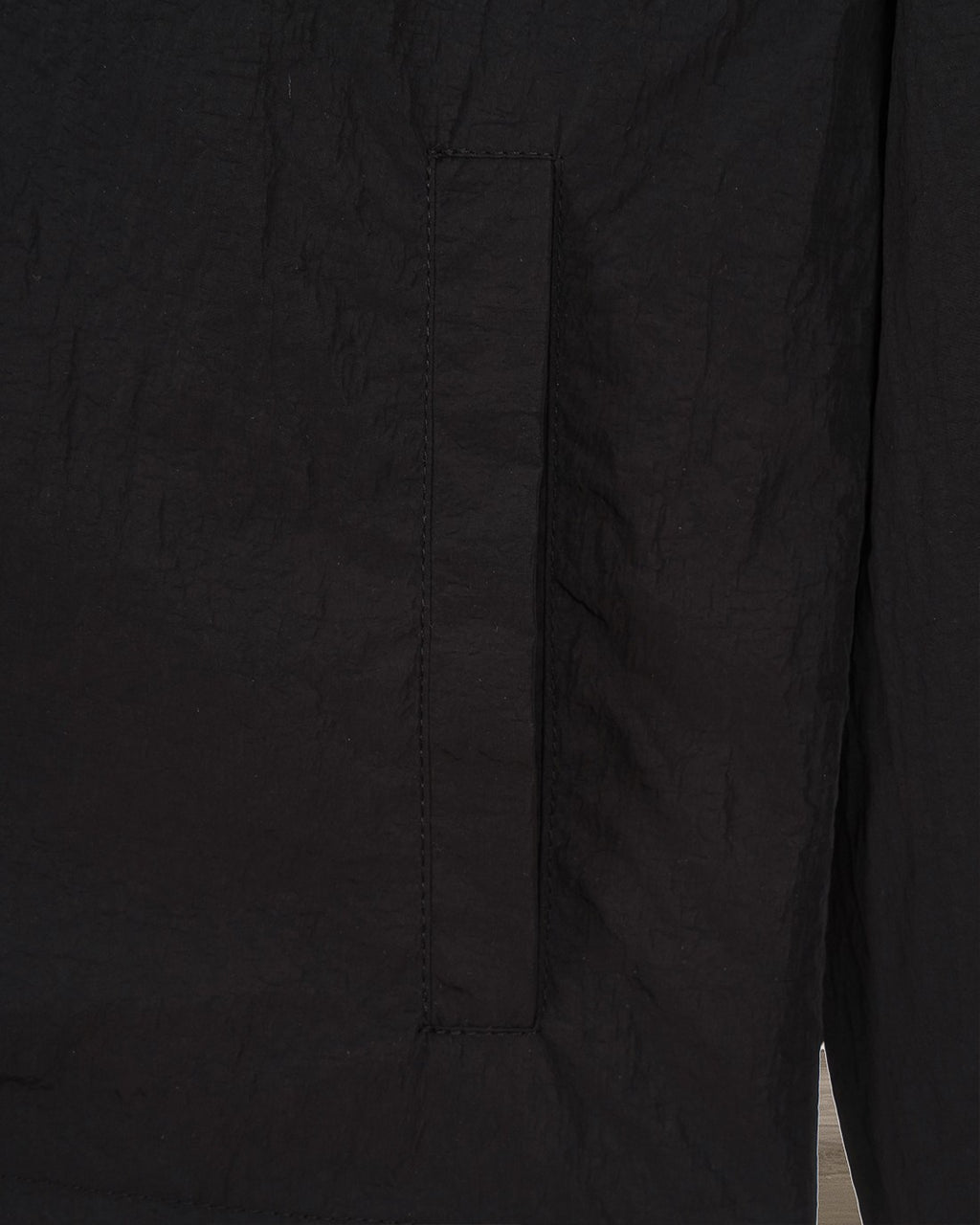 Burberry jacket side panel with stitched seams on dark fabric