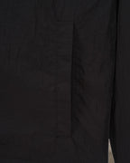 Black jacket side panel seam detail with stitched construction