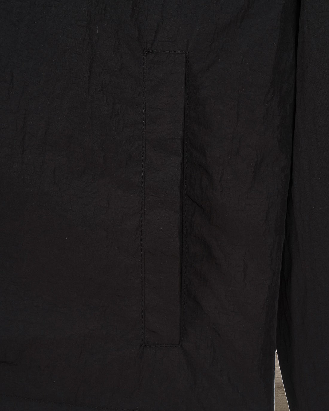 Black jacket side panel seam detail with stitched construction