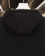 Dark hooded puffer jacket with central back seam and elastic hem