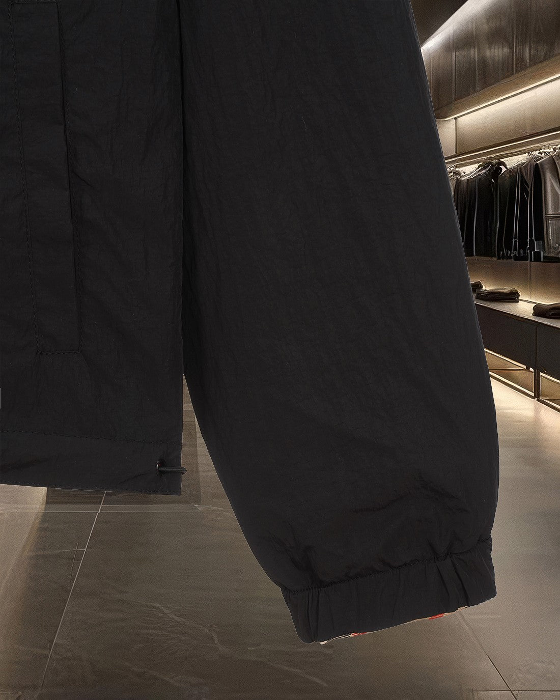 Burberry jacket lower leg seam and elastic hem on dark fabric