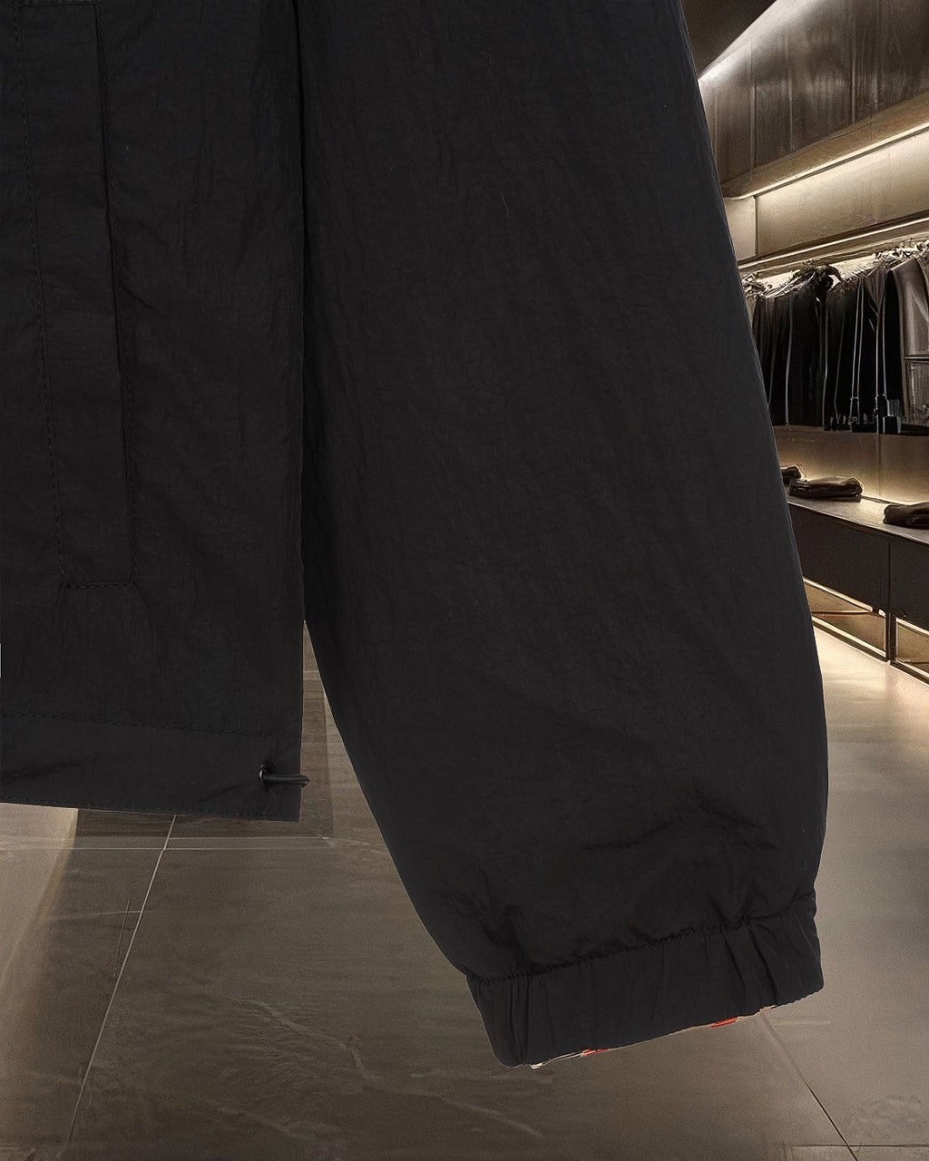 Black jacket sleeve cuff with elastic hem and stitched side seam