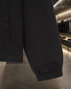 Black jacket sleeve cuff with elastic hem and stitched side seam