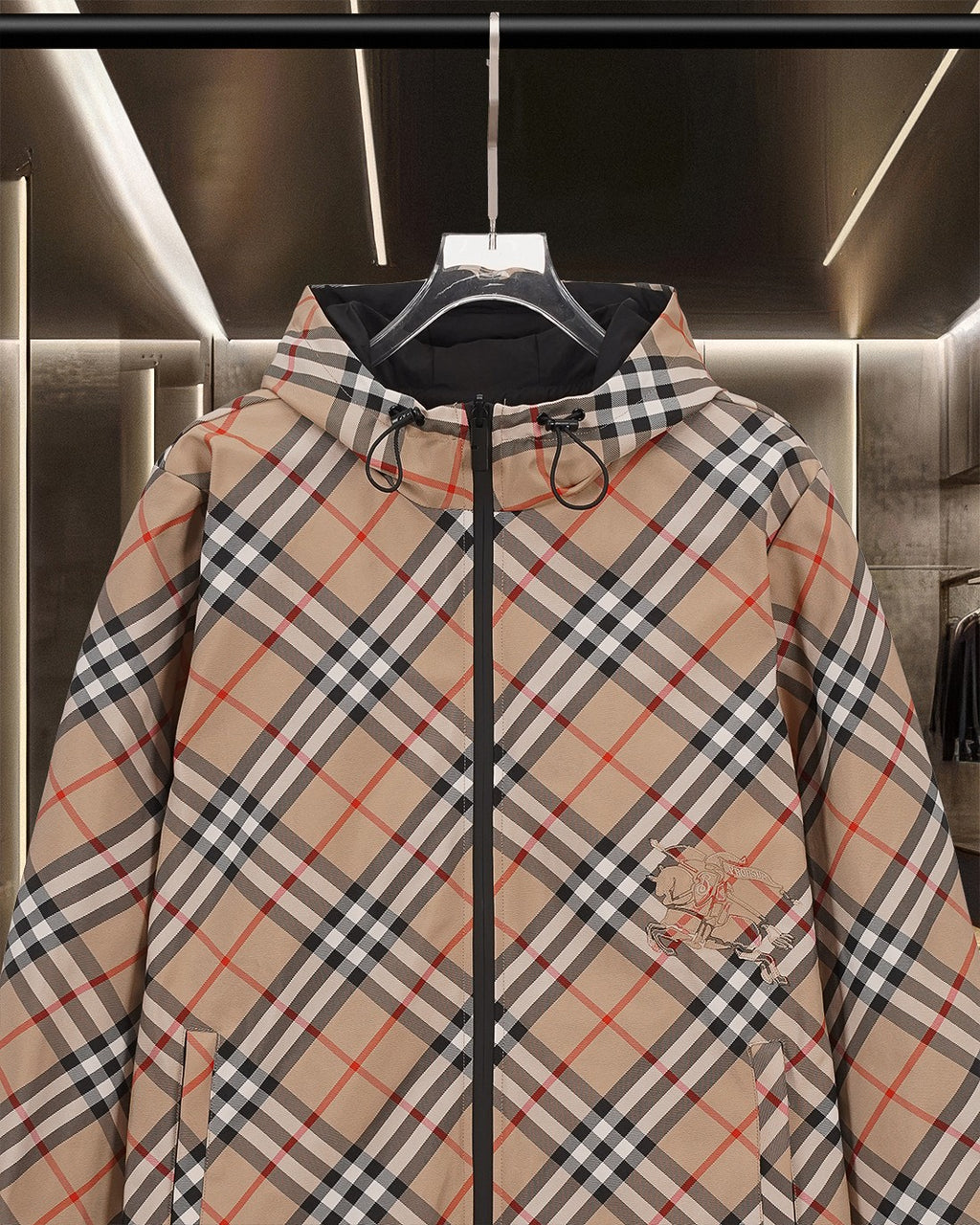 Burberry plaid hooded jacket with black zip, drawstring hood, and chest pocket