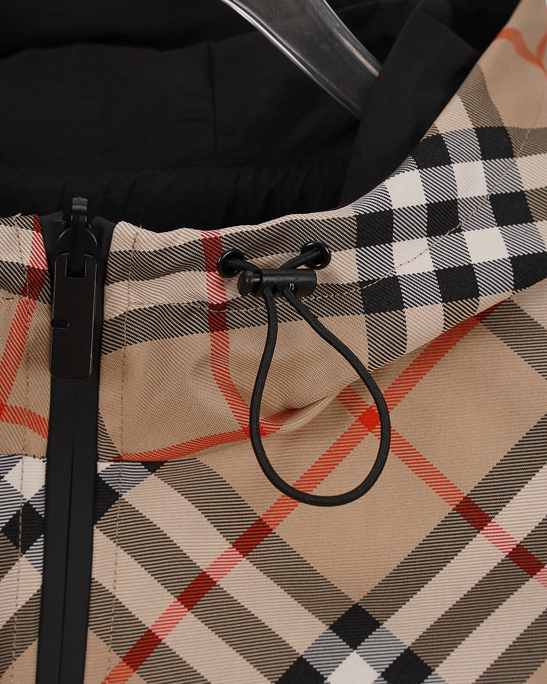 Plaid hooded jacket close-up: black drawstring and toggles at hood opening