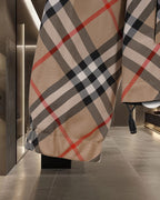 Long coat in beige Burberry check plaid with orange-red and black accents