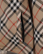 Plaid hooded jacket close-up of front zipper area and fabric paneling