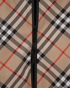 Front zipper and placket on beige, black, and red plaid hooded jacket