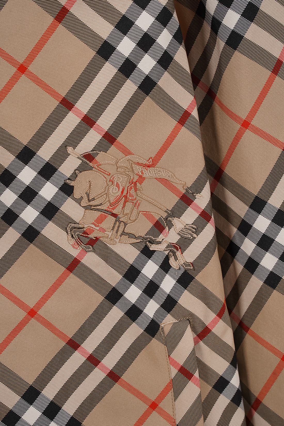 Plaid hooded jacket close-up of embroidered logo patch on the sleeve