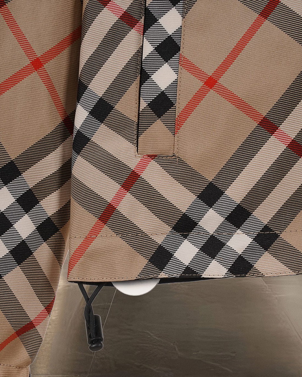 Long coat front with beige Burberry check plaid and partial button placket