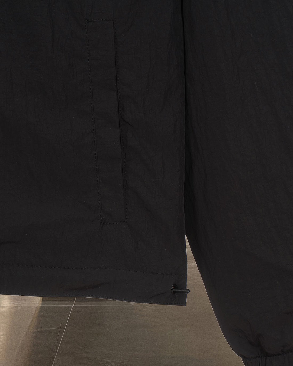 Black jacket lower front section with side pocket and hem fastening