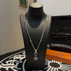 Silver-tone chain necklace on black bust with snowflake pendant and loop clasp
