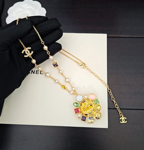 Gold-tone layered necklace with flower charm, pearls, and CC logo link