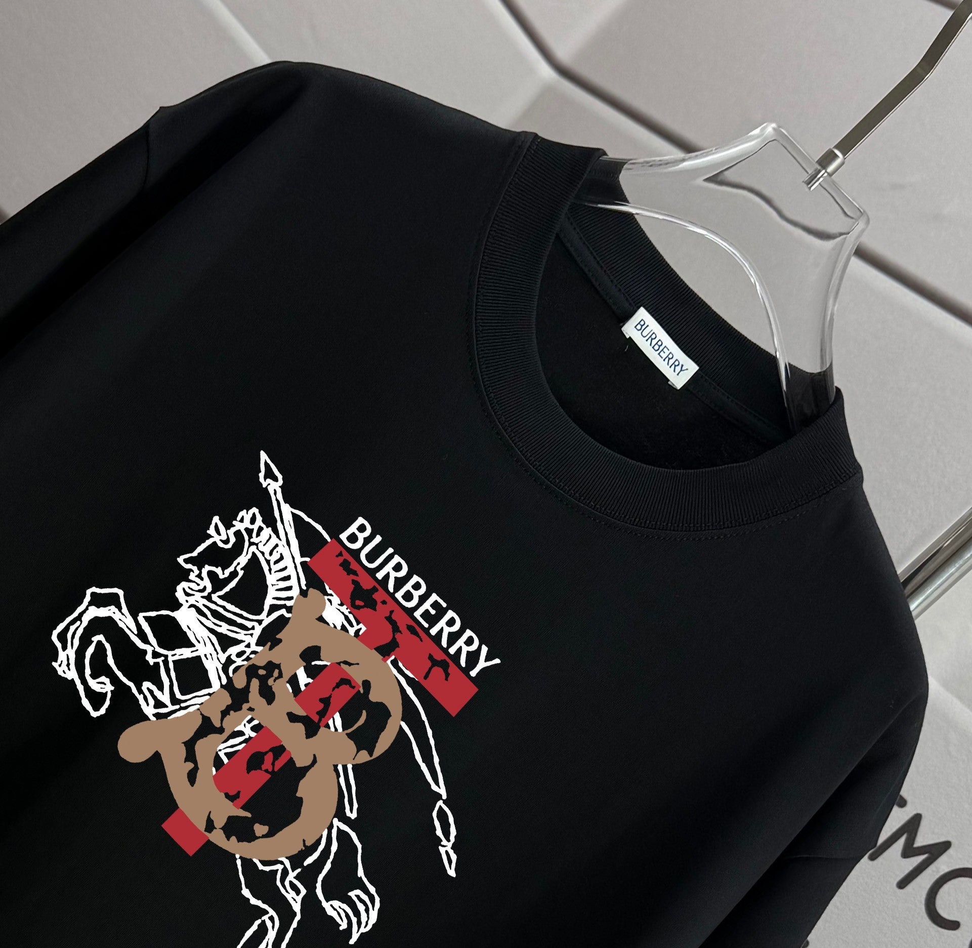Black crew-neck short-sleeve T-shirt with colorful Burberry rider graphic on chest