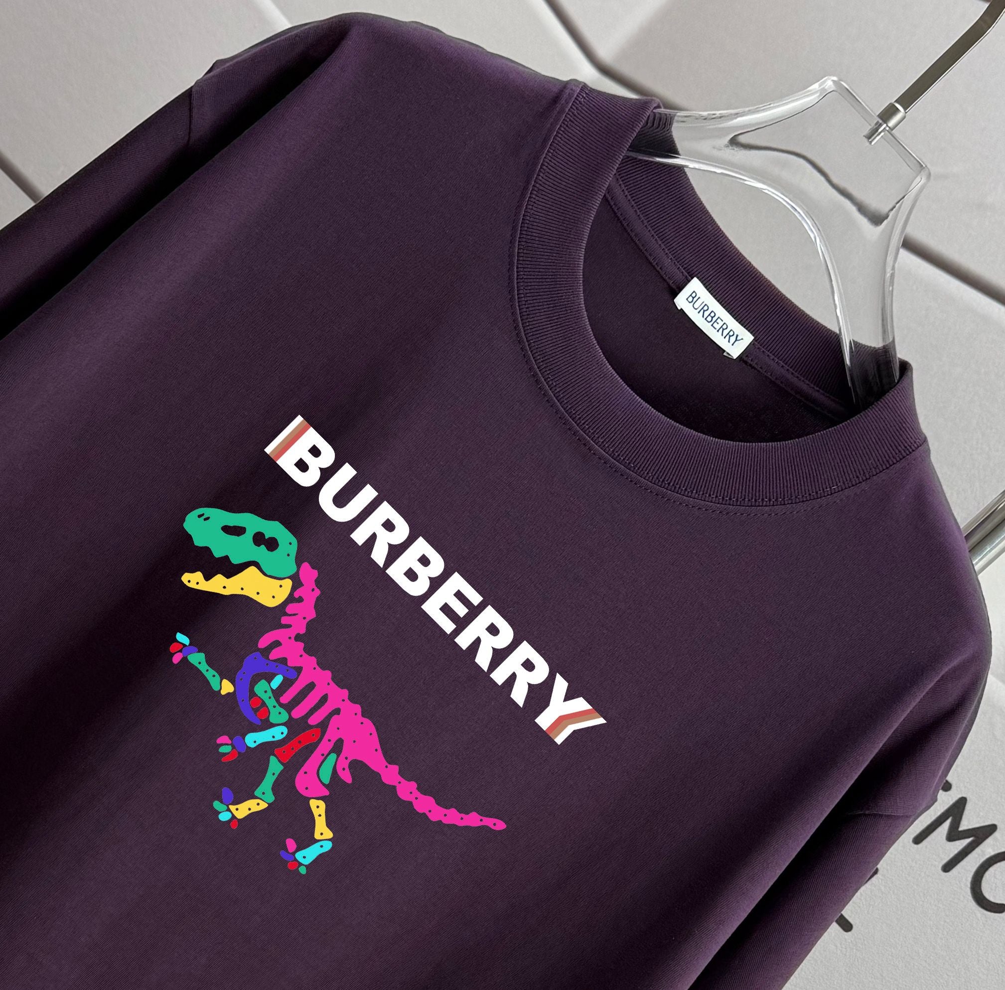 Dark purple Burberry T-shirt closeup with colorful logo graphic on chest
