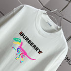 White short-sleeve T-shirt with Burberry text and multicolor dinosaur graphic