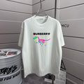 White short-sleeve T-shirt with Burberry logo and colorful dinosaur graphic