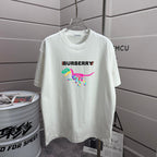 White short-sleeve T-shirt with Burberry logo and colorful dinosaur graphic