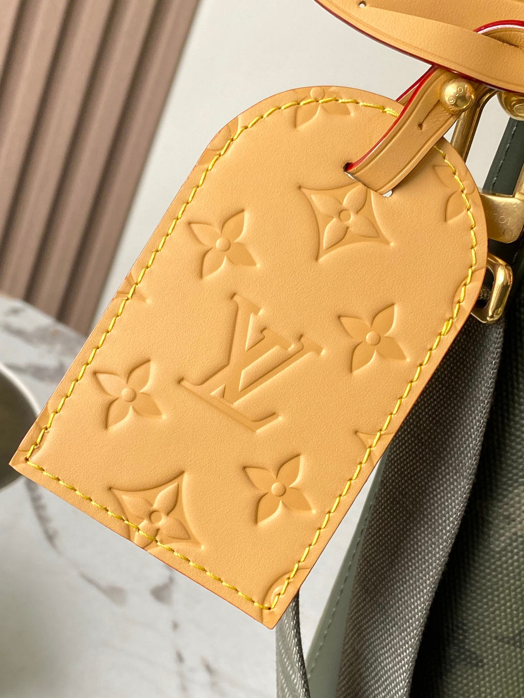 Louis Vuitton embossed leather charm pouch in beige with gold buckle and strap