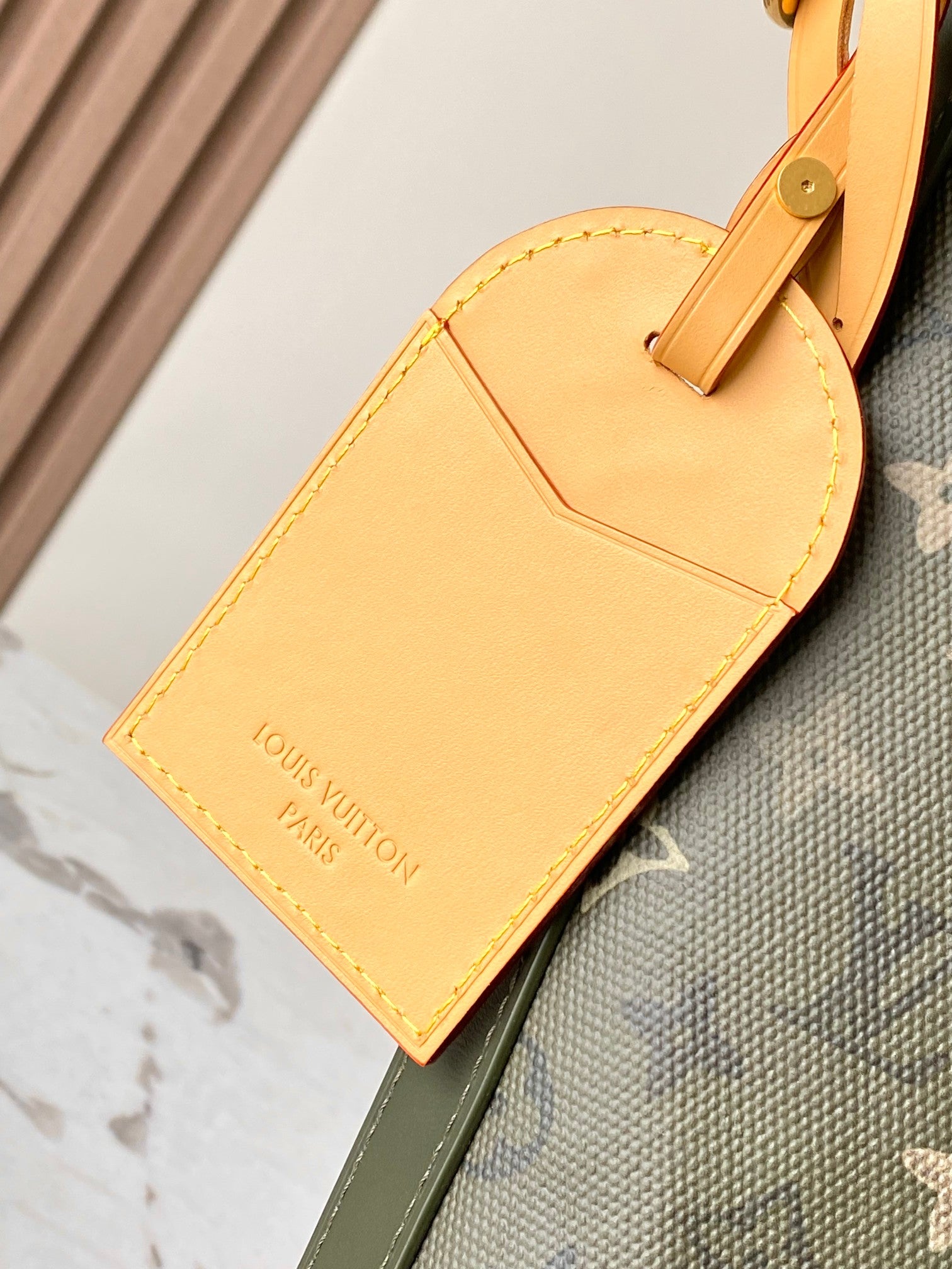 Louis Vuitton bag front flap pocket in beige leather with embossed logo text