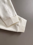 Ribbed knit cuff and hem on marbled light crewneck sweatshirt sleeve