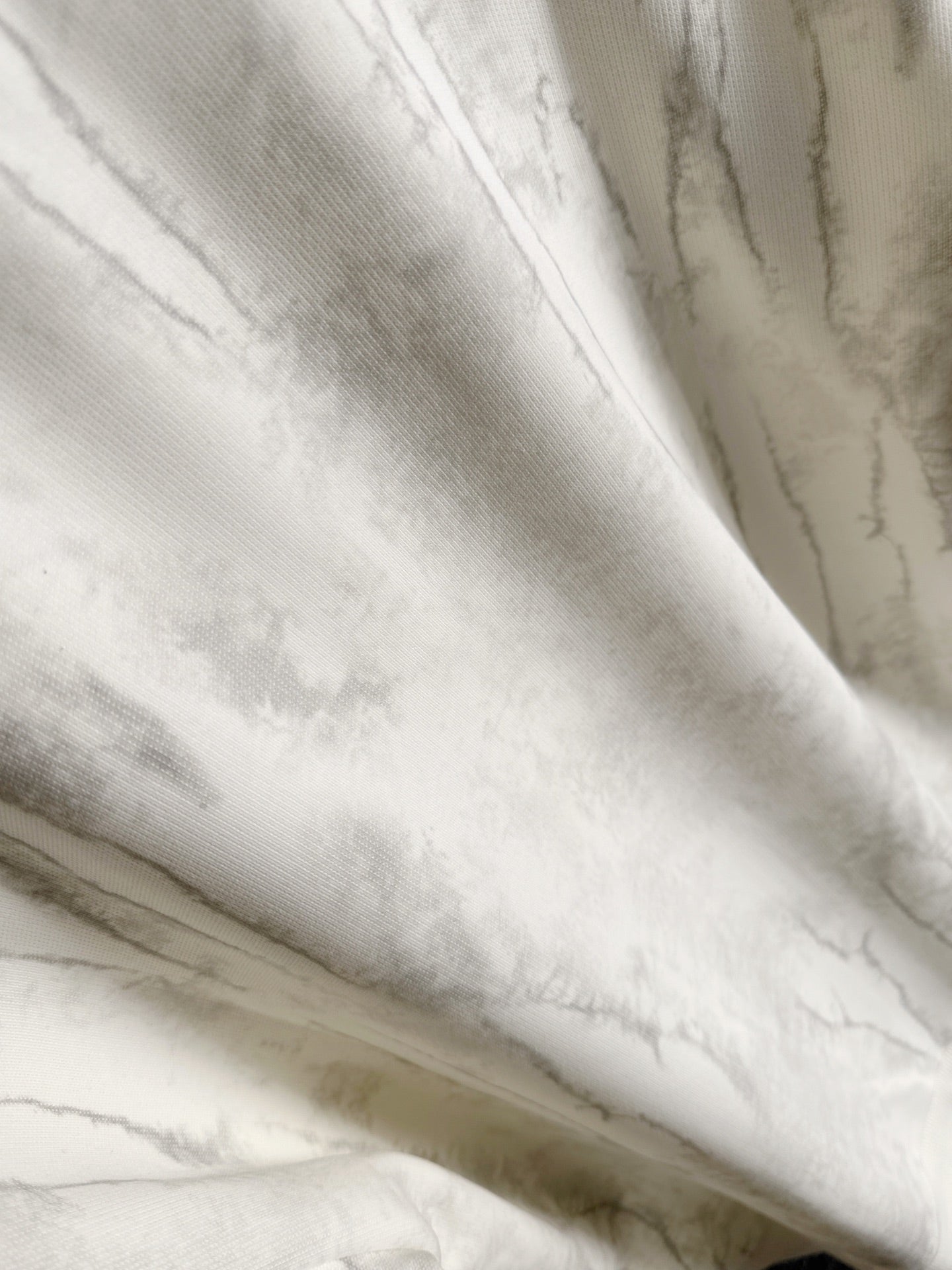 Marbled light fabric detail on a crewneck sweatshirt