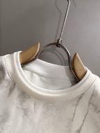 Crewneck sweatshirt neckline with ribbed collar on marbled light fabric