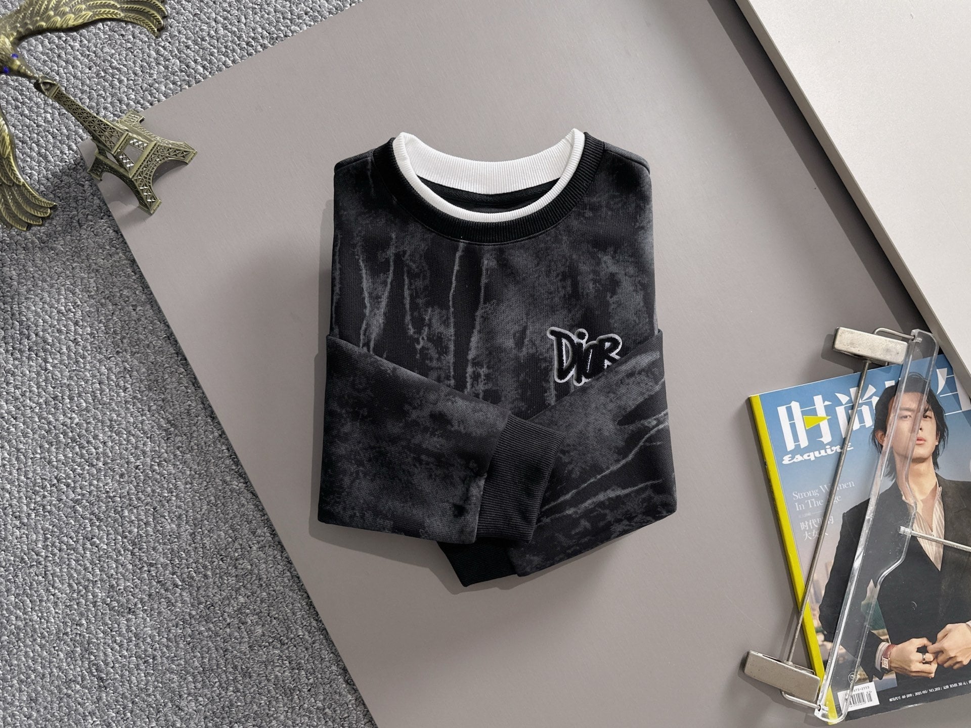 Black long-sleeve sweatshirt with white collar trim and DiR chest logo, crew neck