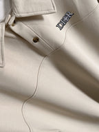 Dior long-sleeve polo shirt close-up of placket and logo on light cream fabric