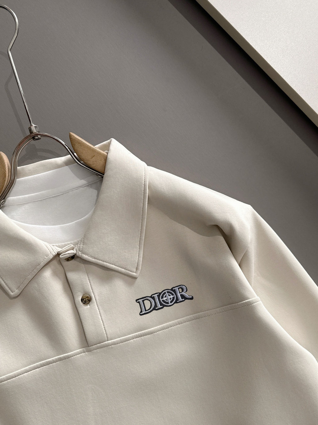 Dior long-sleeve polo shirt close-up of collar and chest logo, light cream