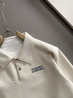 Dior long-sleeve polo shirt close-up of collar and chest logo, light cream