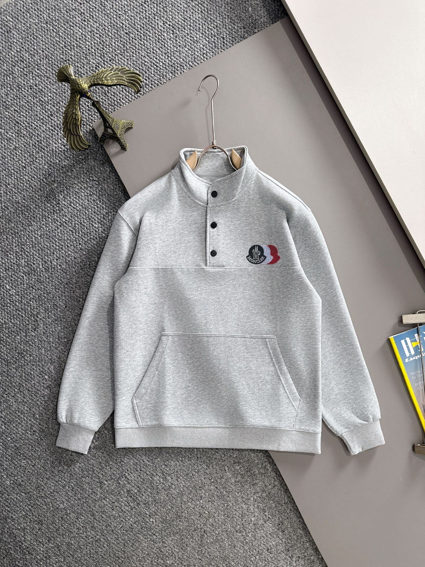 Light gray long-sleeve pullover with button placket and stand collar