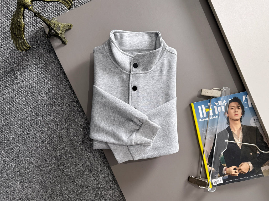 Light gray long-sleeve pullover folded with stand collar and button placket