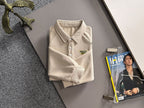 Cream long-sleeve polo shirt with ribbed collar, button front, and Gucci logo patch