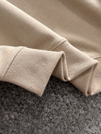 Cream ribbed knit collar and sleeve cuffs on a long-sleeve polo shirt
