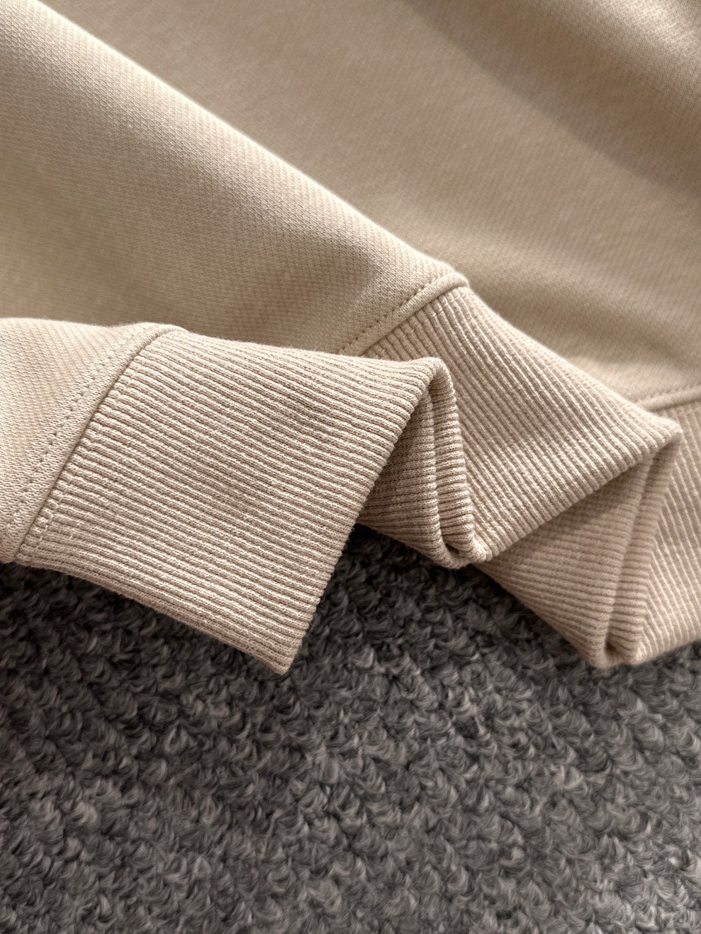 Cream ribbed knit collar and sleeve cuffs on a long-sleeve polo shirt