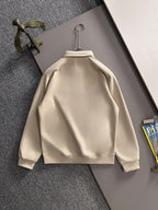 Cream long-sleeve polo shirt back view on hanger with stand collar