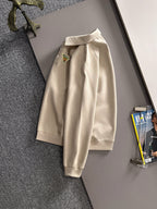 Cream long-sleeve polo shirt with stand collar and button placket, front logo unseen