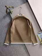 Gucci long-sleeve top on hanger with crew neck, white cuffs, and chest logo